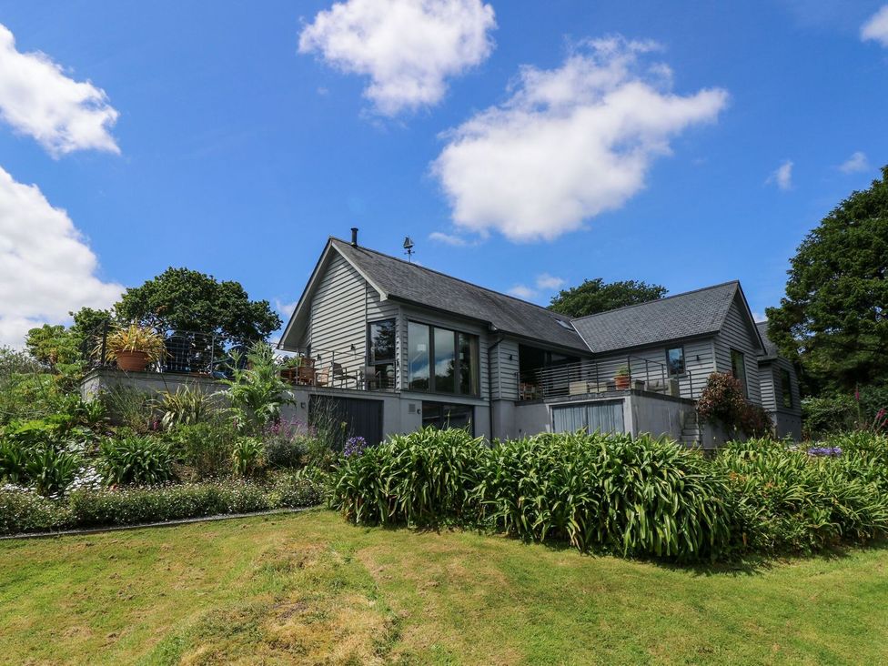 A house with a garden and balcony at Wood Meadow in Helston