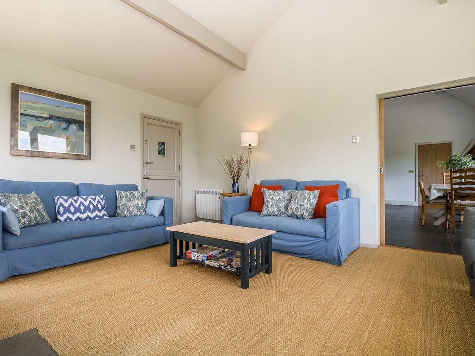 A living room with sofas and a coffee table at Wood Meadow in Helston