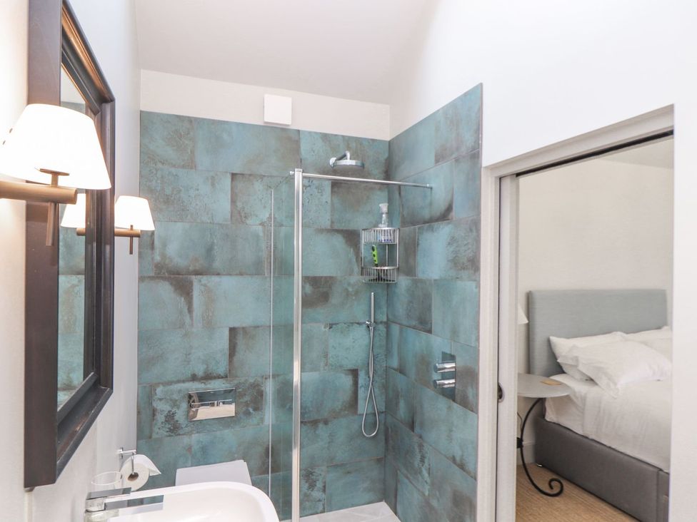 A bathroom with shower and wash basin at Wood Meadow in Helston
