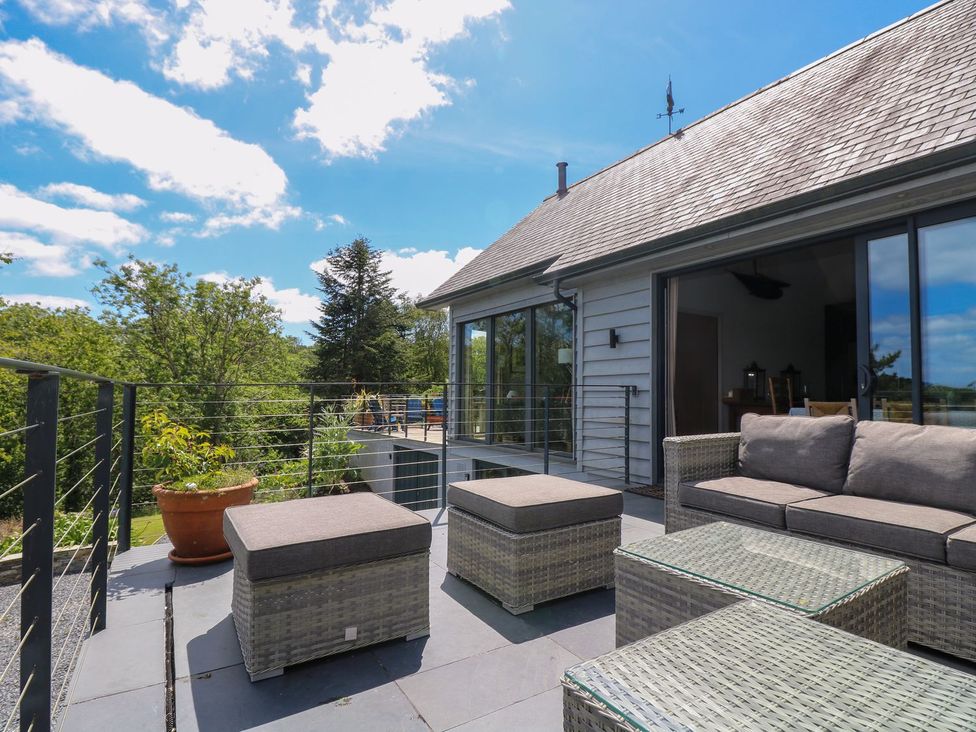 An outdoor seating area with furniture at Wood Meadow in Helston
