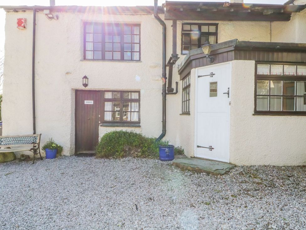 An outdoor area with a door, windows, and a bench at Farmhouse Cottage in Keswick