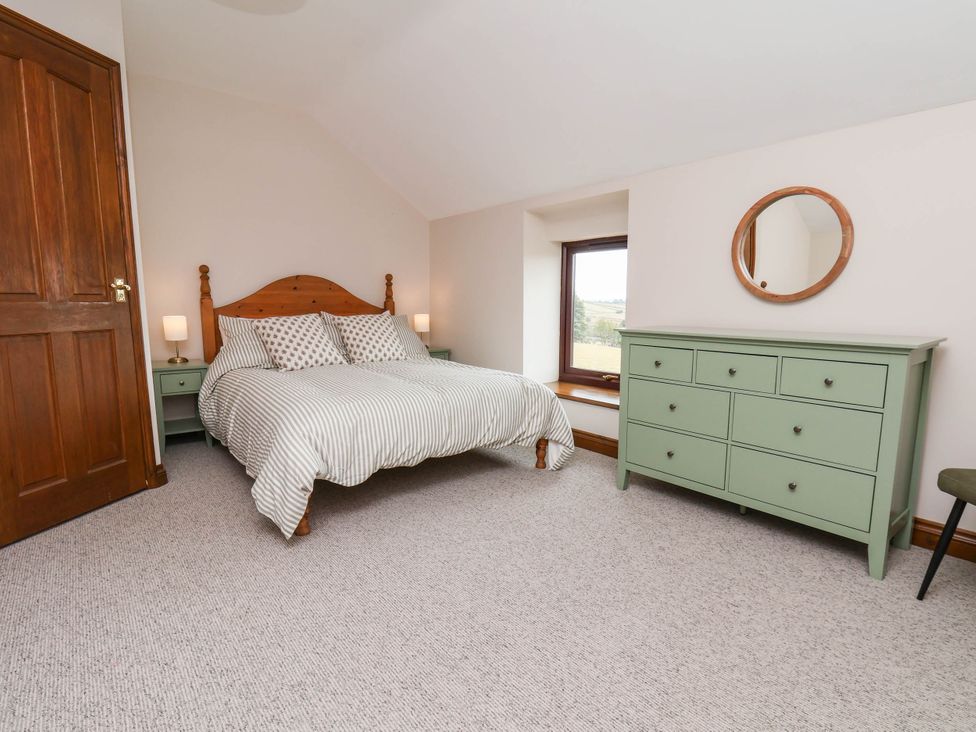 A bedroom with a bed and dresser at Wren's Nest in Lealholm