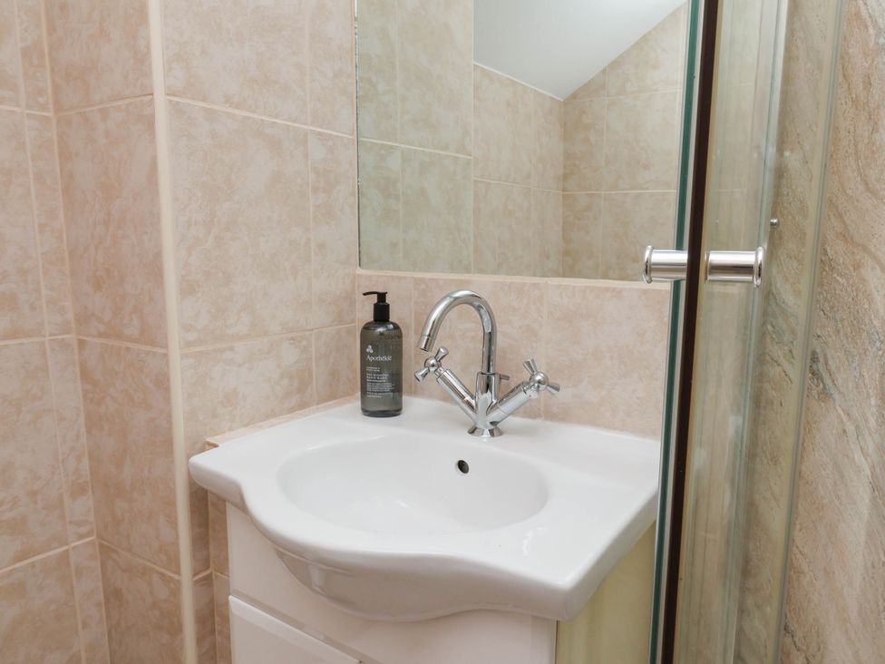 A bathroom with a sink and shower at Wren's Nest in Lealholm