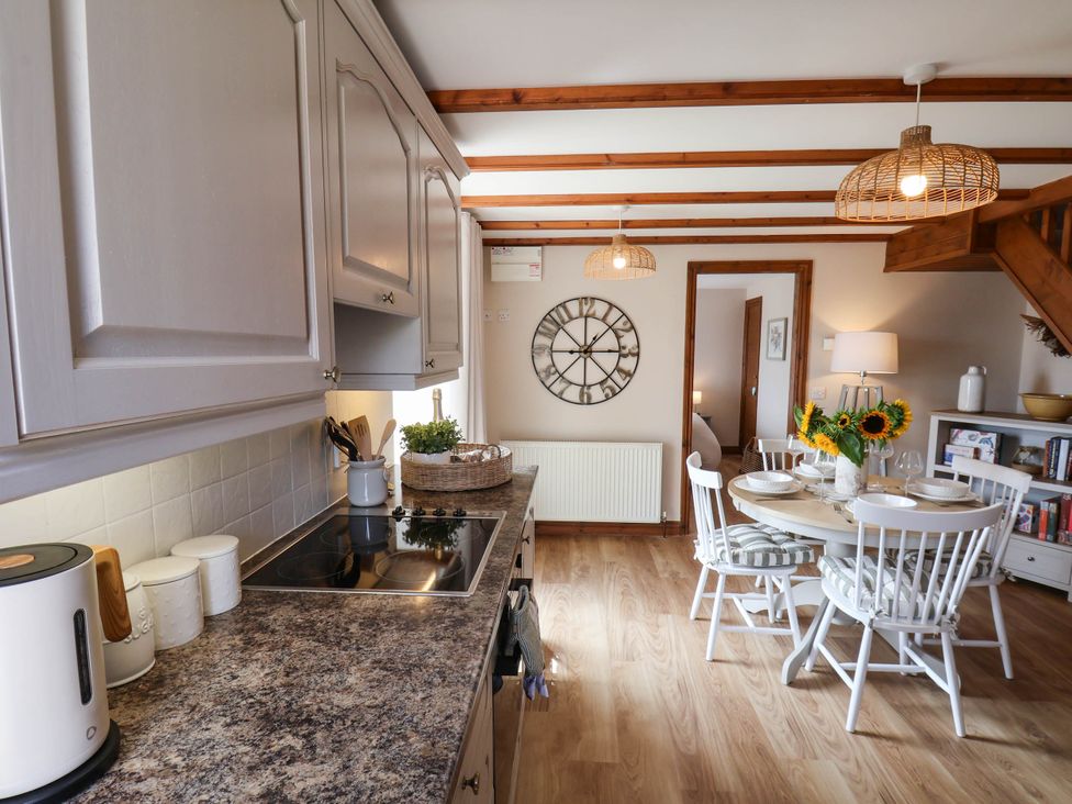 A kitchen with dining area at Swallow Cottage in Lealholm