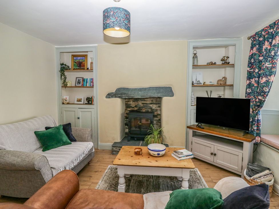 A living room with a television and fireplace at Bobbin Nook