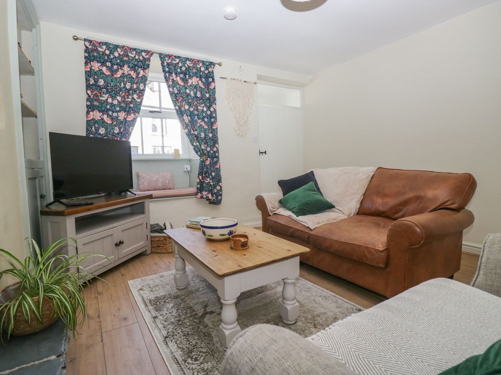 A living room with a sofa and television at Bobbin Nook 