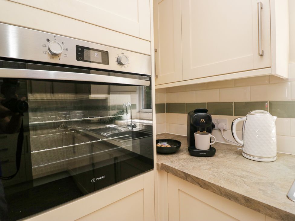 A kitchen with an oven and coffee machine at Bobbin Nook