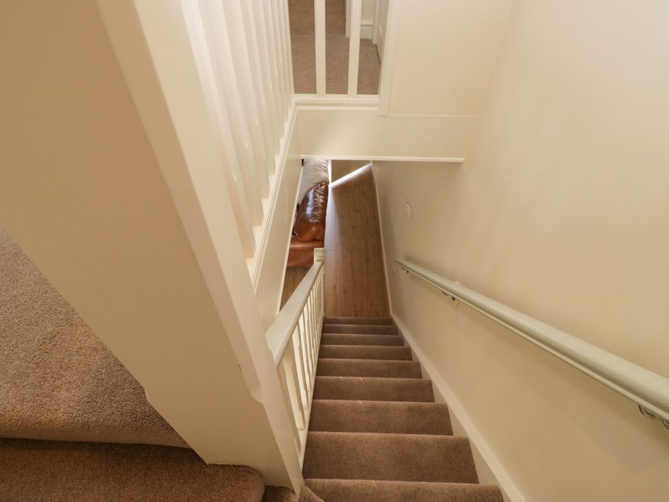 A staircase with carpet and a railing at Bobbin Nook in 