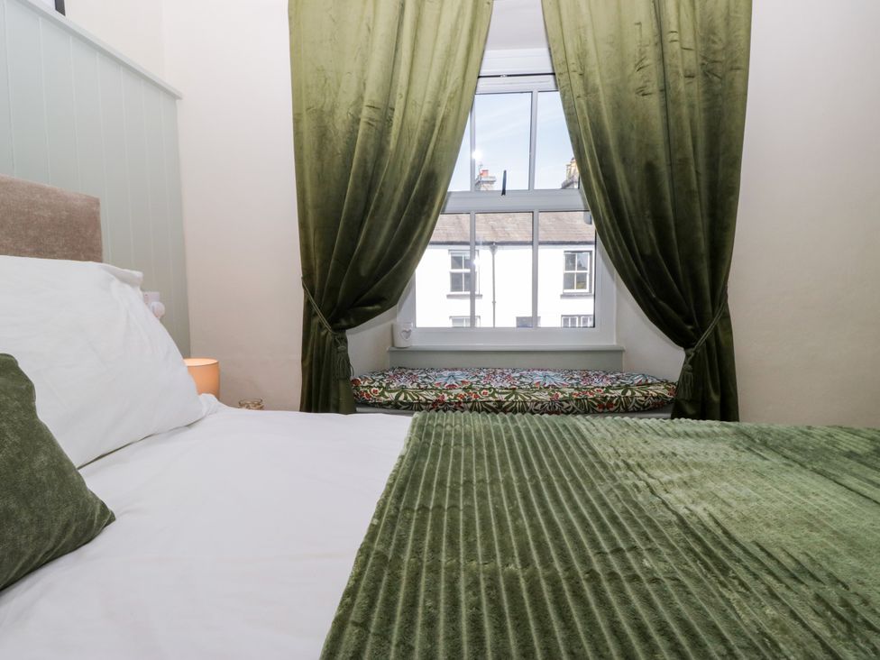 A bedroom with a bed and window seat at Bobbin Nook