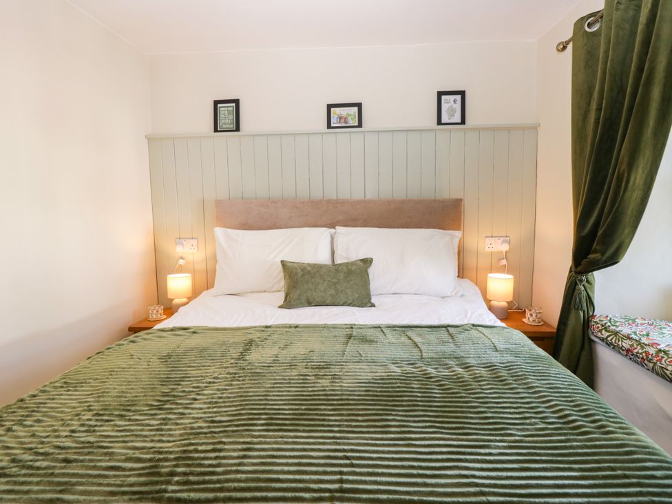 A bedroom with a bed and lamps at Bobbin Nook 