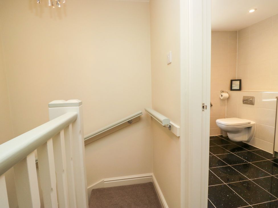 A staircase leading to a bathroom with a toilet at Bobbin Nook