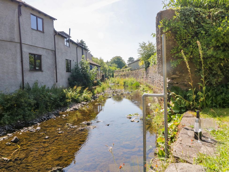 A view of a stream and houses at Bobbin Nook in 