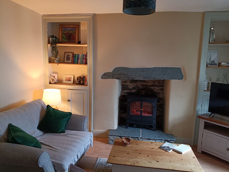 A living room with a sofa and fireplace at Bobbin Nook in Staveley