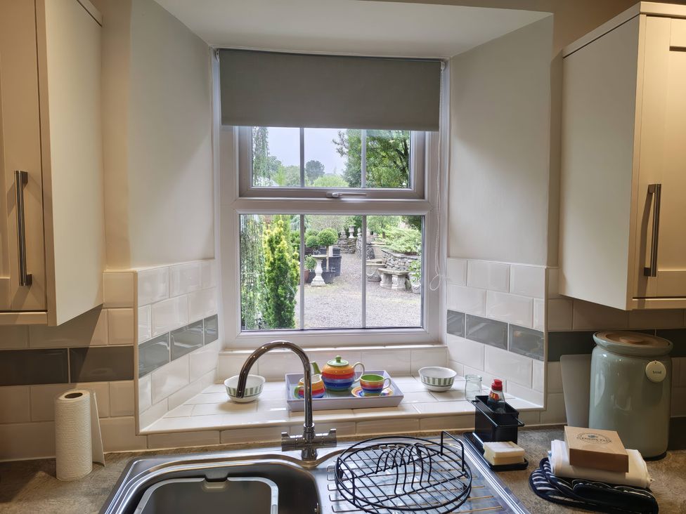 A kitchen with a sink and window overlooking a garden at Bobbin Nook in Staveley