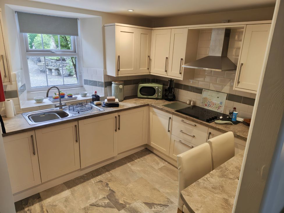A kitchen with a sink and stove at Bobbin Nook in Staveley