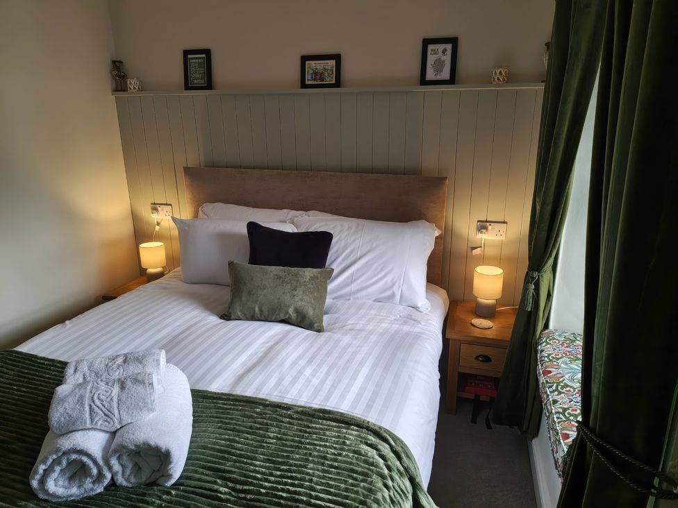 A bedroom with a bed and bedside tables at Bobbin Nook in Staveley
