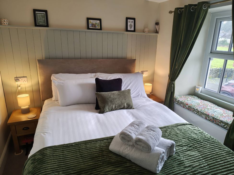 A bedroom with a bed and bedside table at Bobbin Nook in Staveley