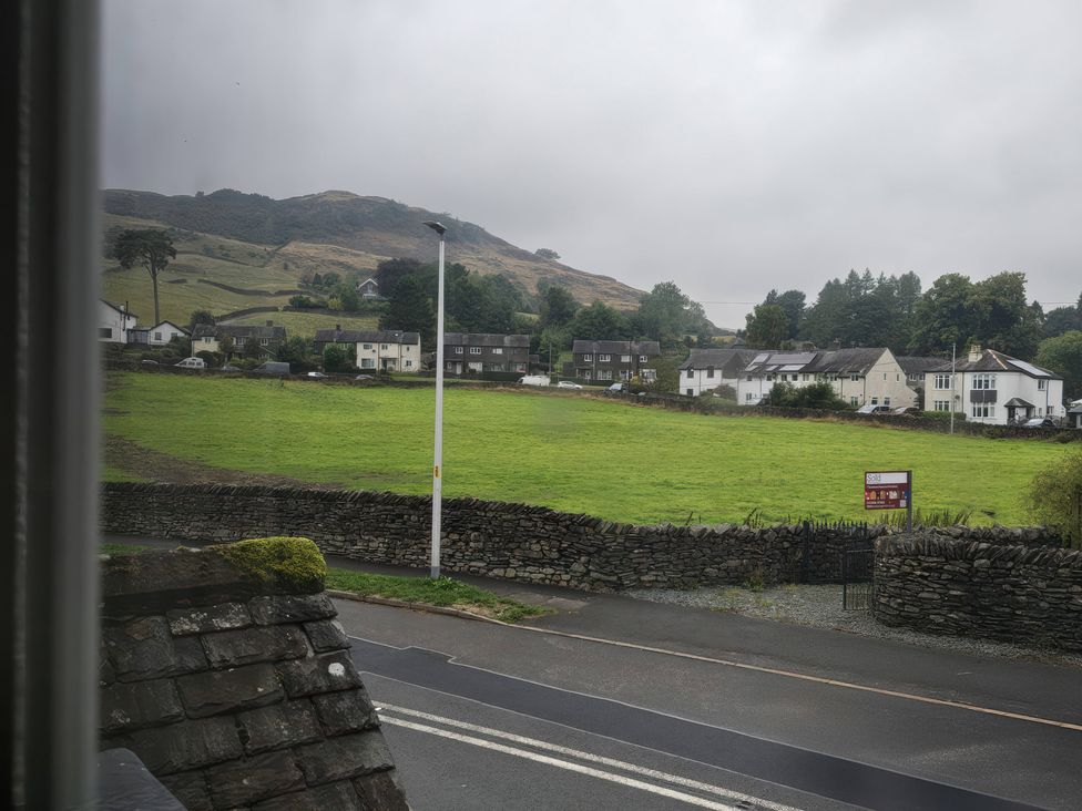 A view of houses and hills from a window at Bobbin Nook in Staveley