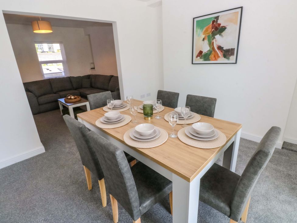 A dining room with a table set for dinner at Mountain View Cottage Ystradgynlais