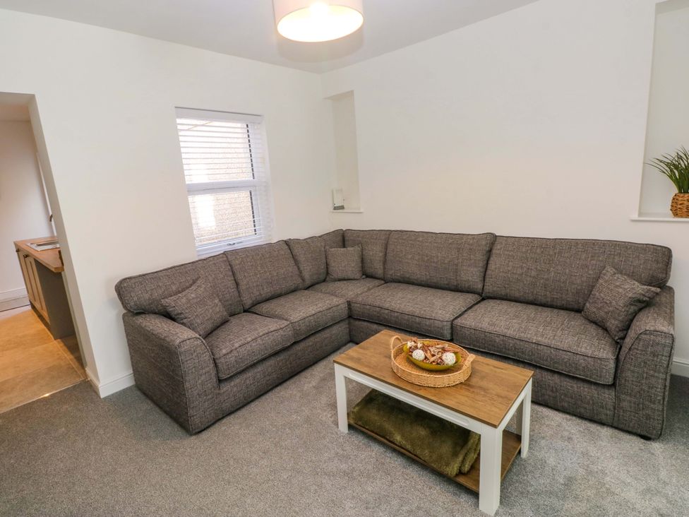 A living room with a sofa and coffee table at Mountain View Cottage in Ystradgynlais
