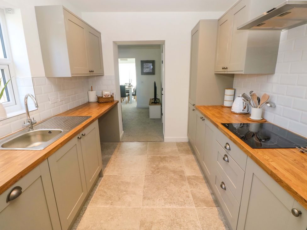 A kitchen with cabinets and countertops at Mountain View Cottage Ystradgynlais