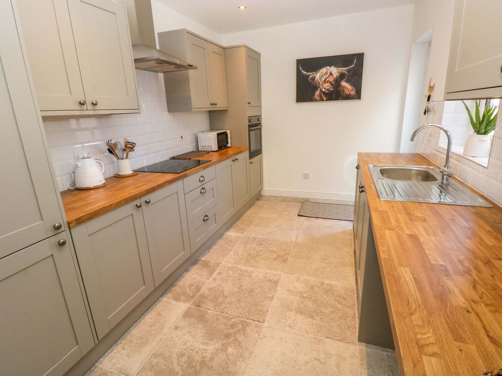 A kitchen with cabinets and countertop at Mountain View Cottage in Ystradgynlais