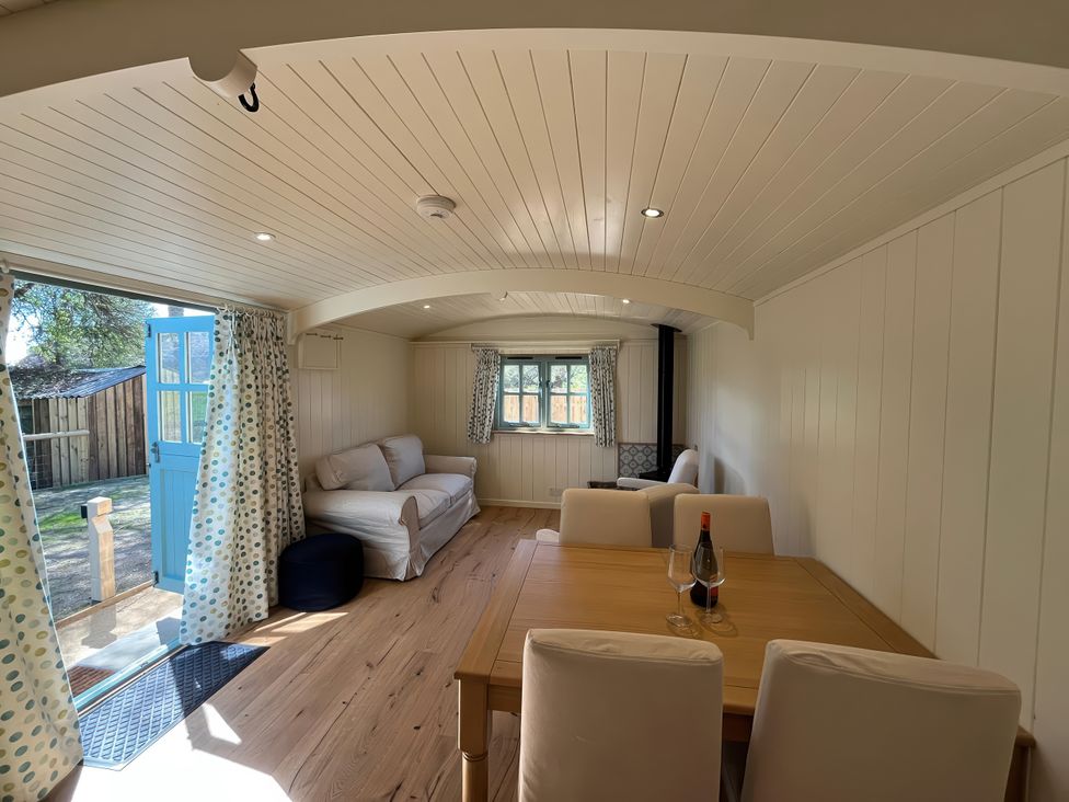 A living room with a sofa and table at The Orchard in Ringstead