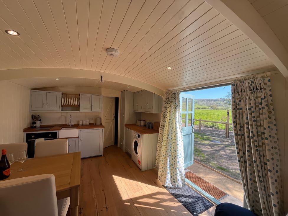 A kitchen with a table and chairs at The Orchard in Ringstead