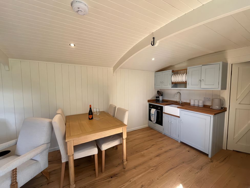 A kitchen with dining table and chairs at The Orchard in Ringstead