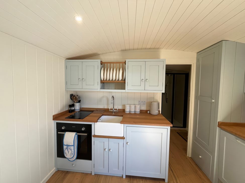 A kitchen with cabinets and a sink at The Orchard in Ringstead