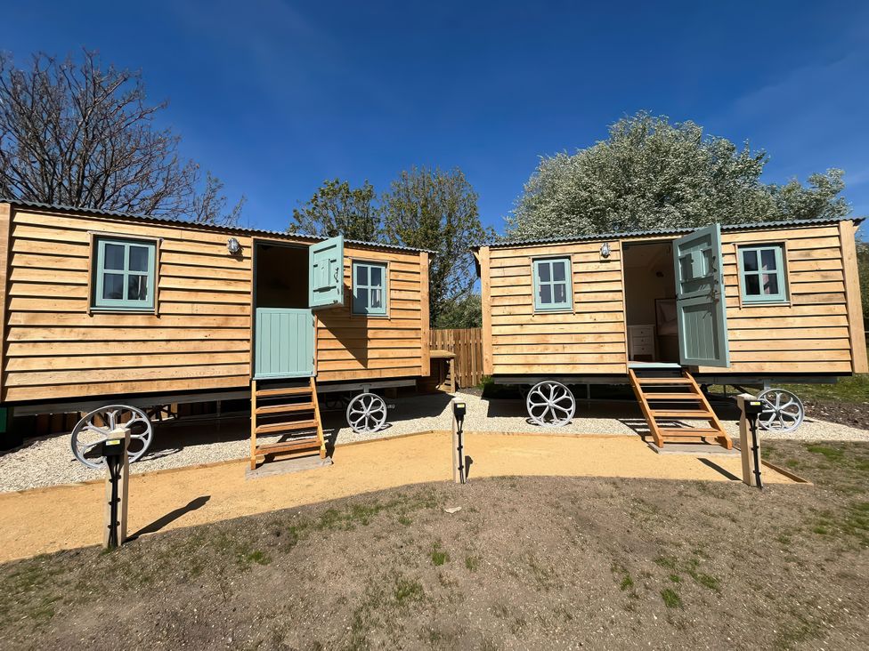 Two wooden structures with steps in an outdoor area at The Orchard in Ringstead