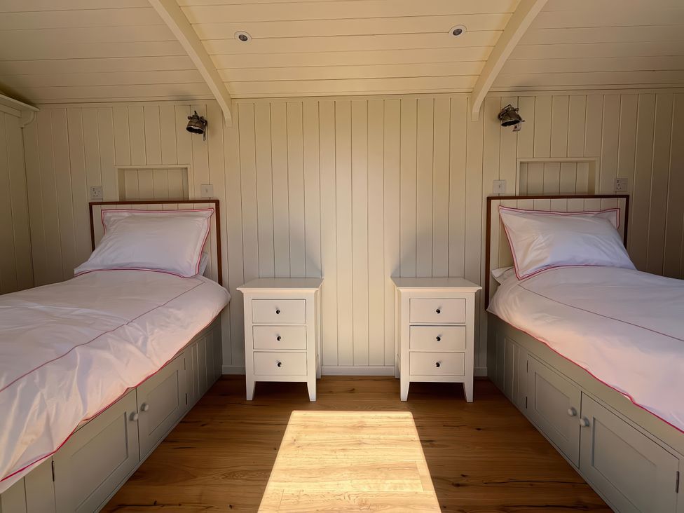 A bedroom with two beds and nightstands at The Orchard in Ringstead