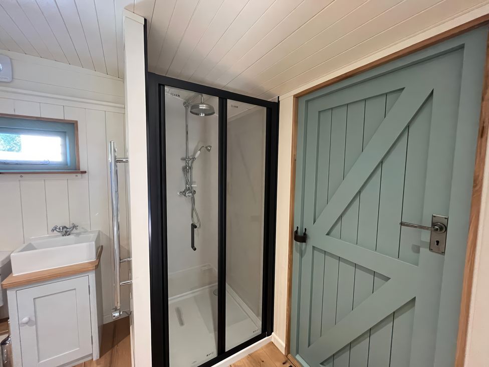 A bathroom with a shower and washbasin at The Orchard in Ringstead