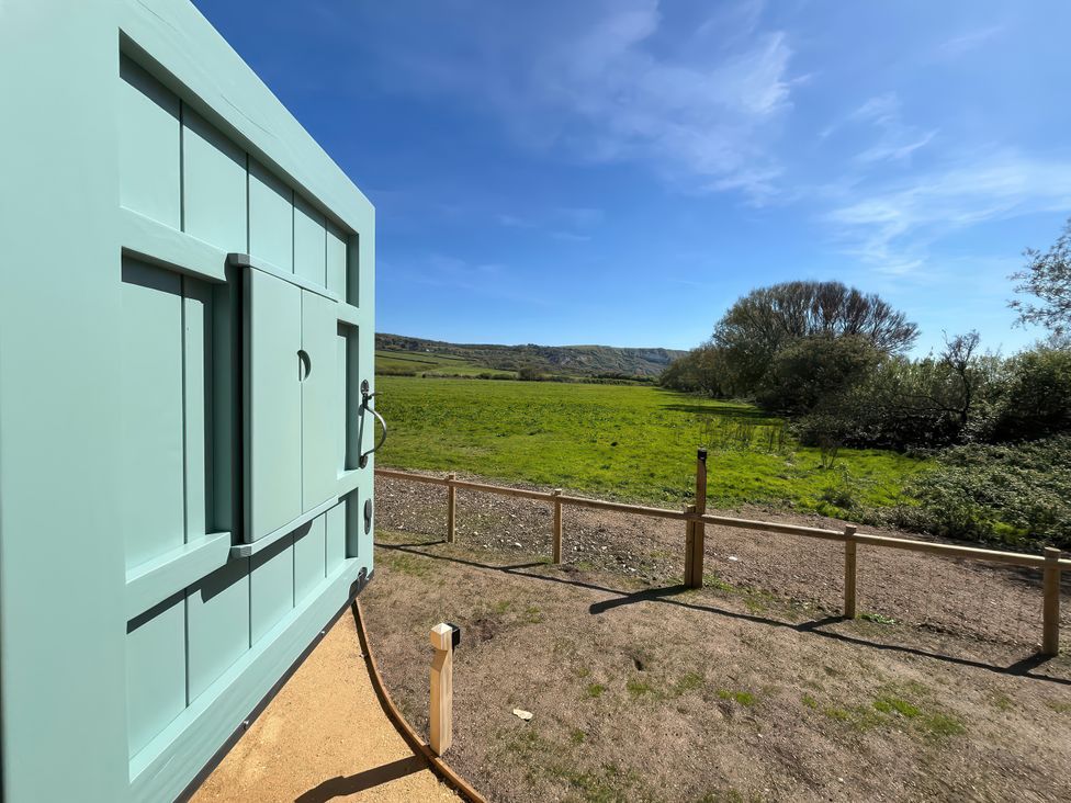 A door with a view of grass and trees at The Orchard in Ringstead