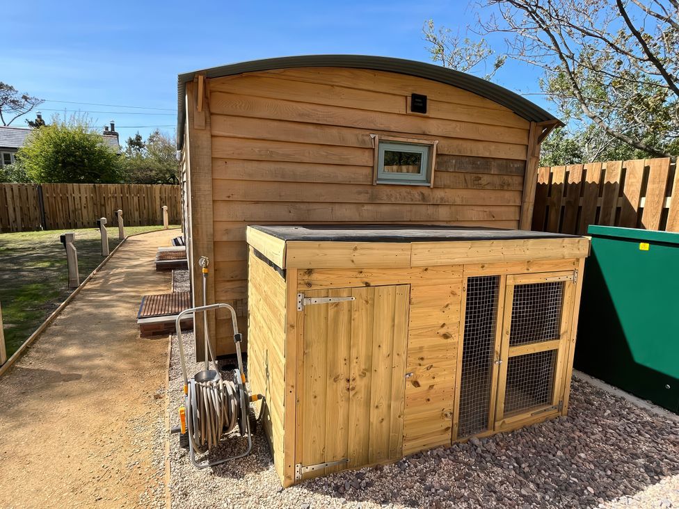A shed with a storage unit and garden hose at The Orchard in Ringstead