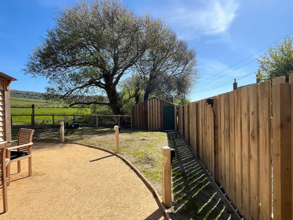 An outdoor area with a tree and a shed at The Orchard in Ringstead