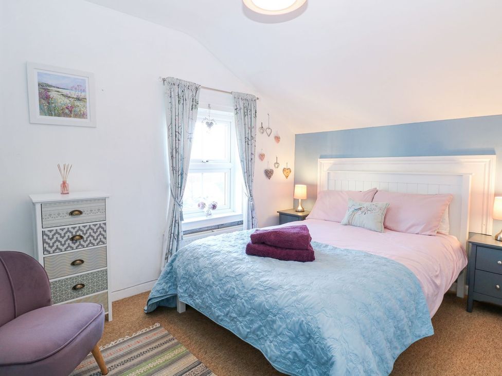 A bedroom with bed and furniture at Hideaway Cottage in Hunstanton
