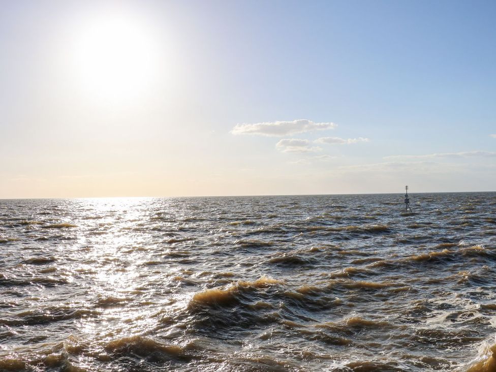 A view of the ocean with waves and a buoy at Hideaway Cottage in Hunstanton