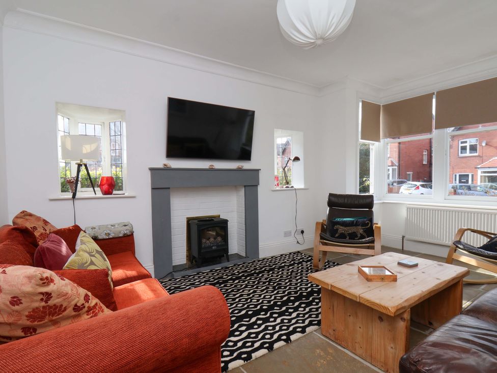 A living room with a television mounted on the wall at 11 Peasholm Avenue Scarborough