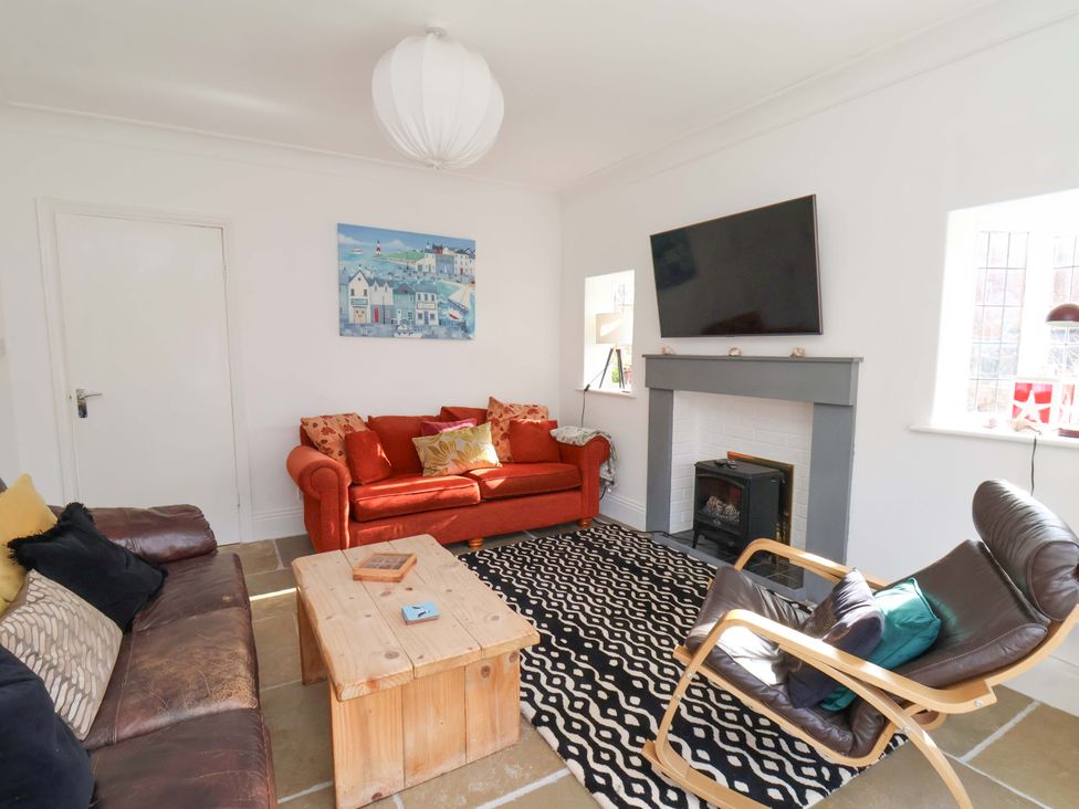 A living room with a sofa and television at 11 Peasholm Avenue Scarborough