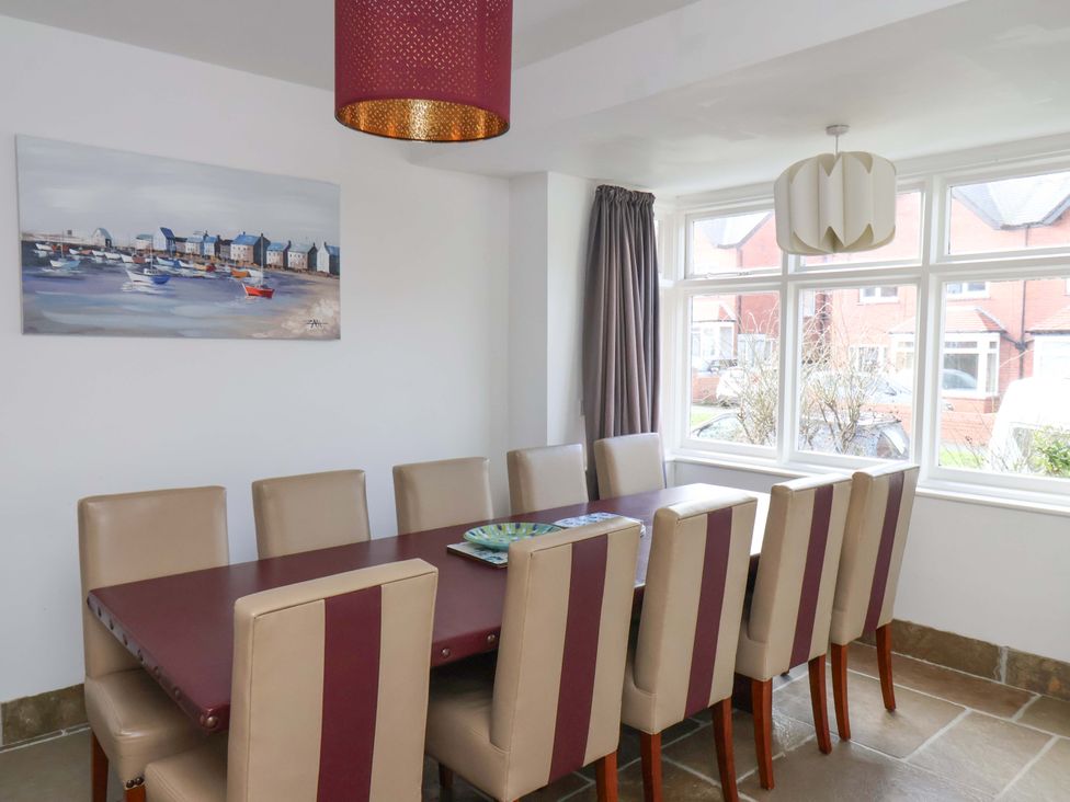 A dining room with a table and chairs at 11 Peasholm Avenue in Scarborough