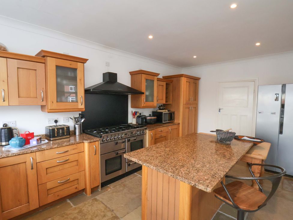 A kitchen with wooden cabinets and a countertop at 11 Peasholm Avenue in Scarborough