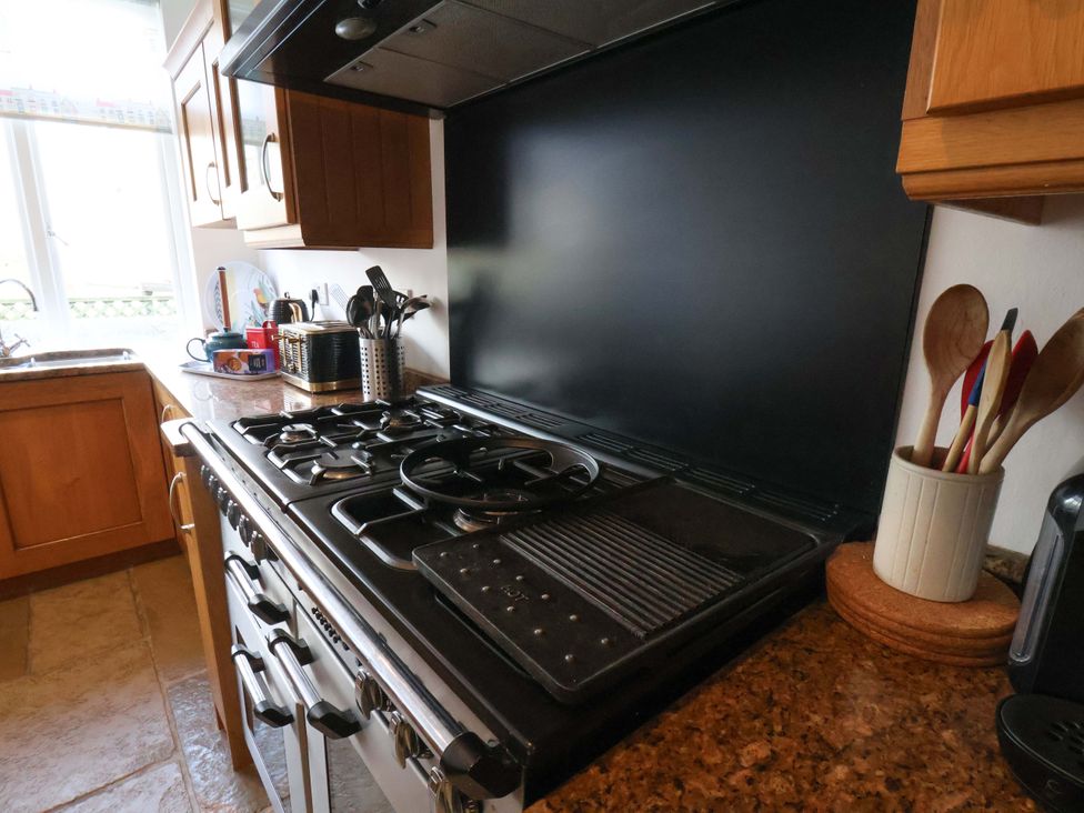 A kitchen with a gas stove and grill surface at 11 Peasholm Avenue Scarborough