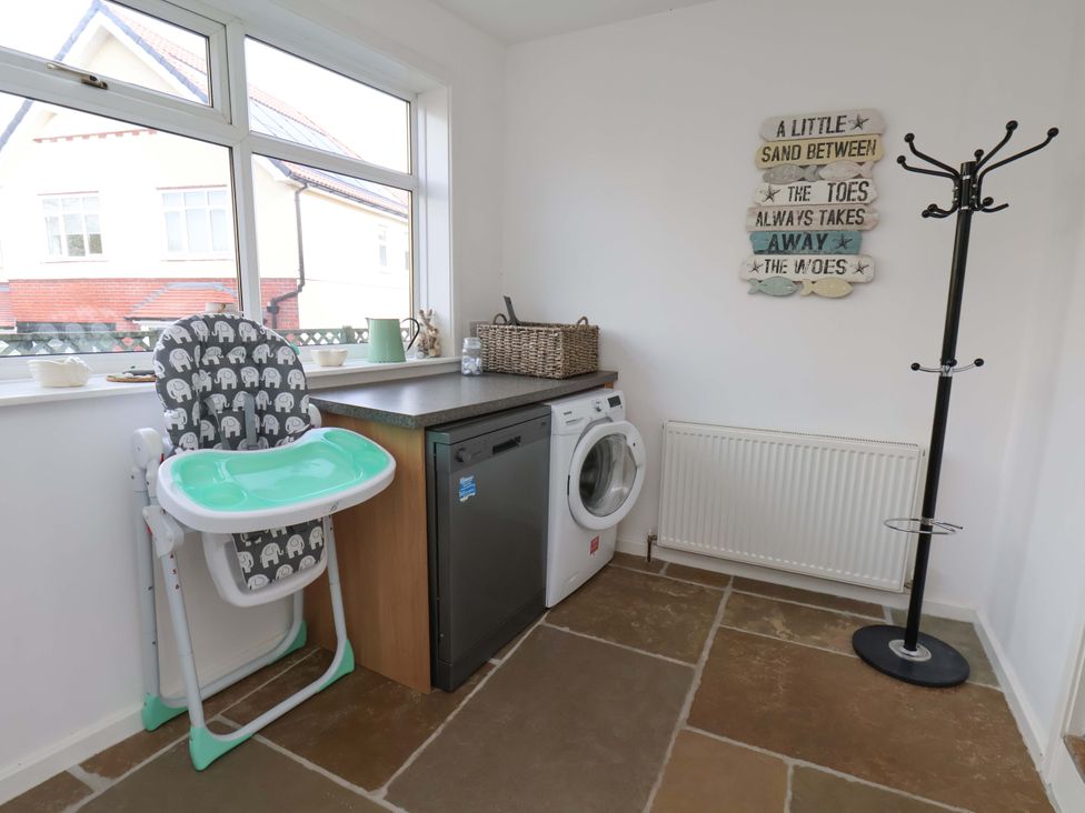 A utility room with a dishwasher and washing machine at 11 Peasholm Avenue in Scarborough