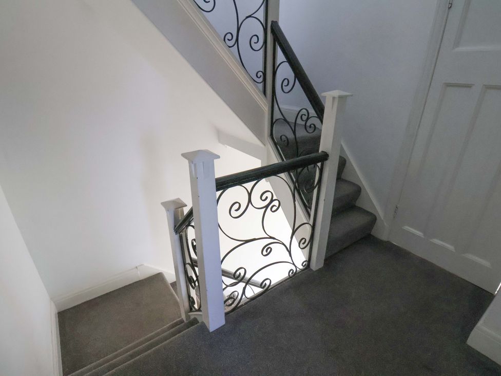 A staircase with a banister and carpet at 11 Peasholm Avenue Scarborough