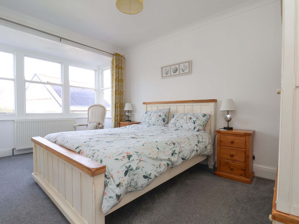 A bedroom with a bed and nightstand at 11 Peasholm Avenue in Scarborough