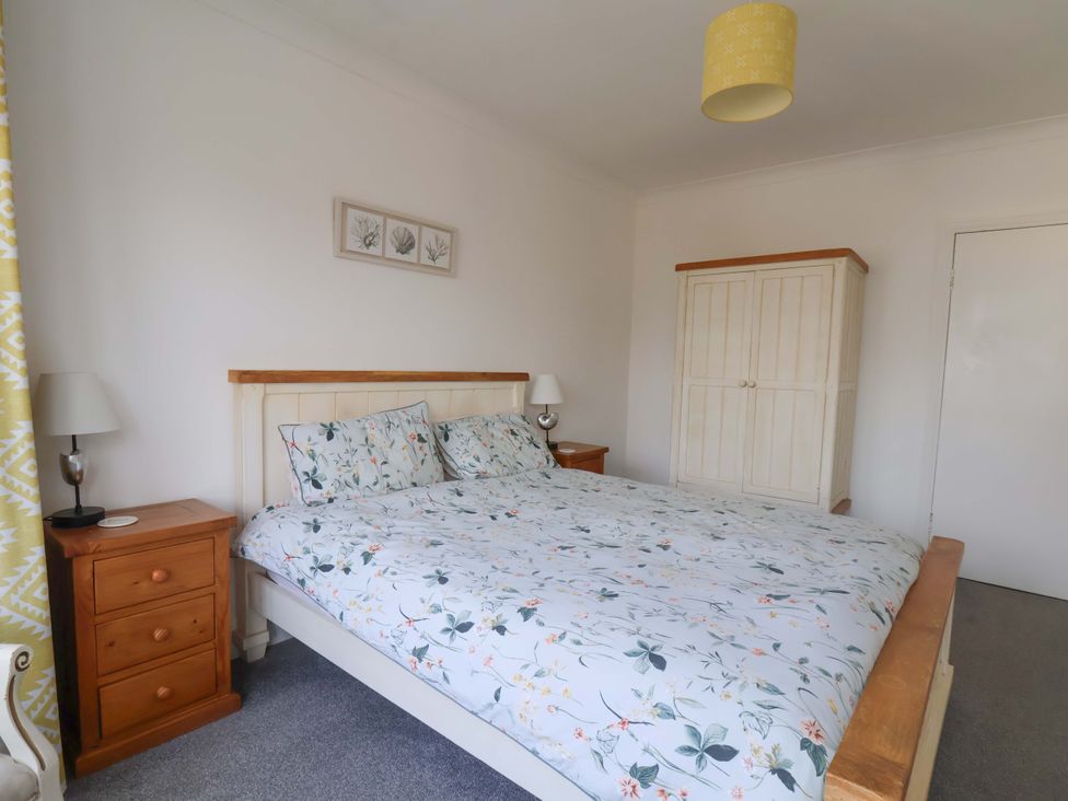 A bedroom with a bed and wardrobe at 11 Peasholm Avenue in Scarborough