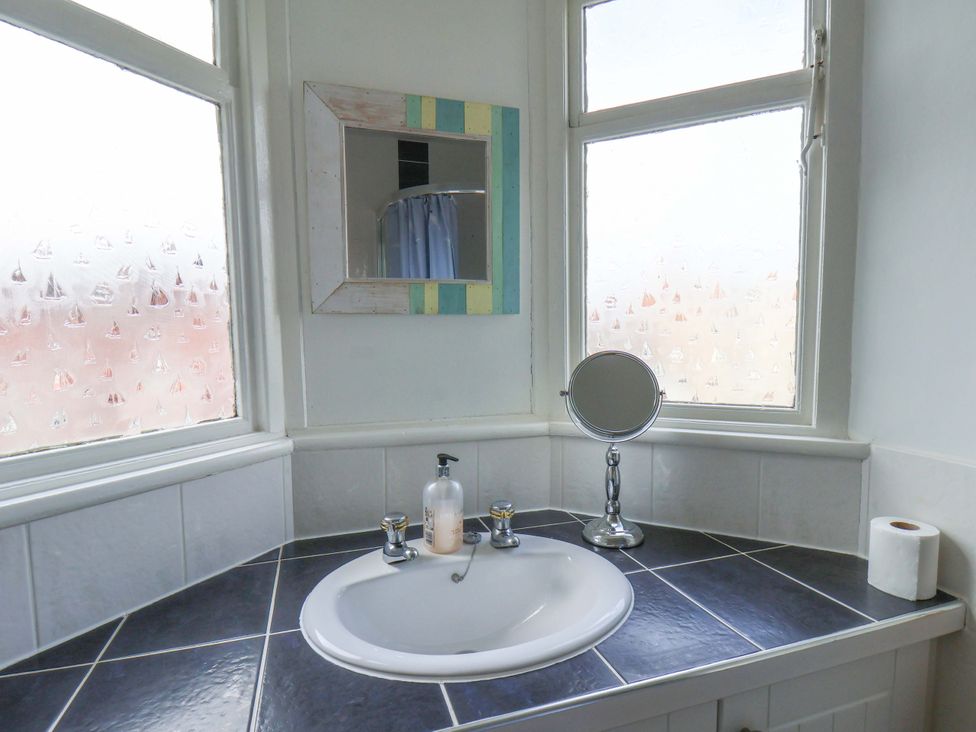 A bathroom with a sink and mirror at 11 Peasholm Avenue, Scarborough