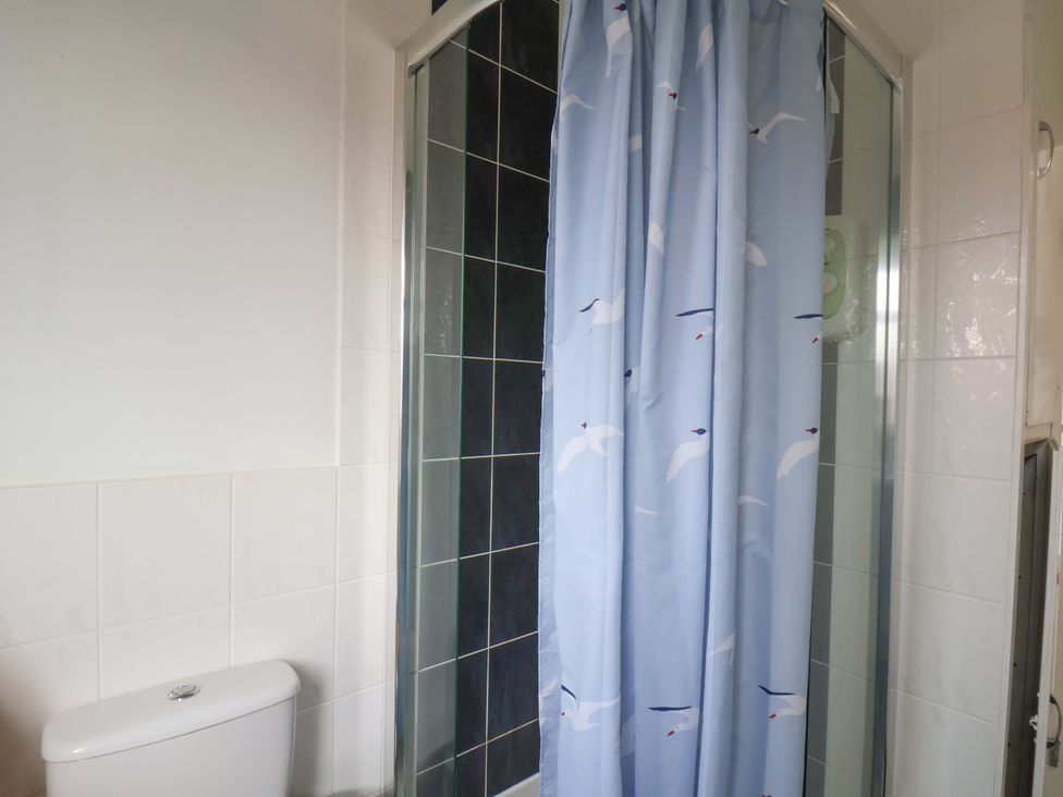 A bathroom with a toilet and a shower at 11 Peasholm Avenue in Scarborough