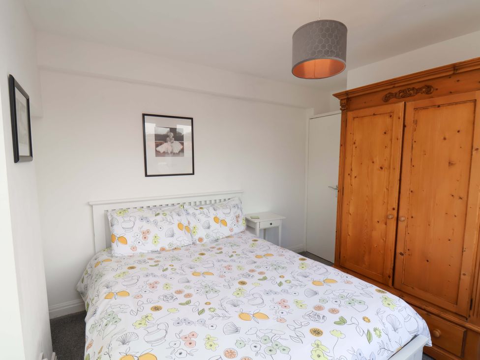 A bedroom with a bed and wardrobe at 11 Peasholm Avenue in Scarborough